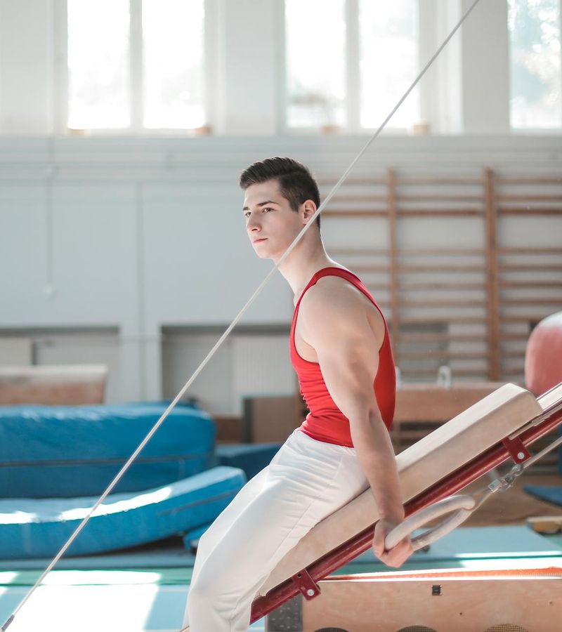 Athletic man in a focused pose during a strength exercise.